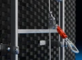 Guided fall arrester ladder lifeline with a tensioned 8 mm wire rope anchor line. Features a self-locking fall arrest device for safe ladder ascent and descent.